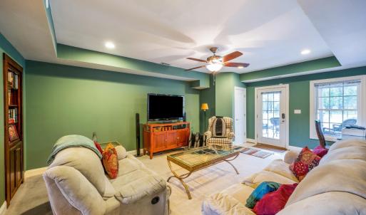 Terrace level great room with built in bookcase, closet and door to terrace garden and patio