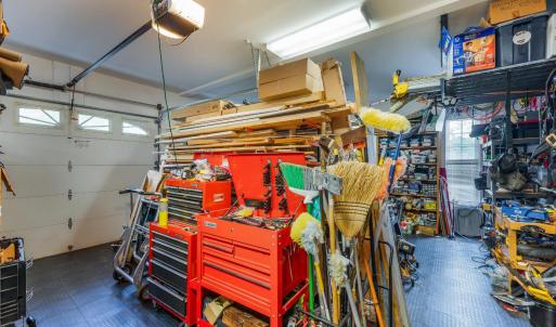 Three bay garage, workshop area with built in cabinets, and fantastic slip proof flooring