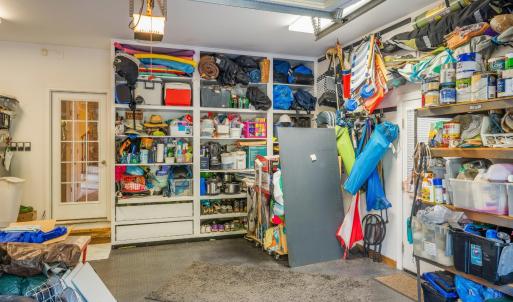 Three bay garage, workshop area with built in cabinets, and fantastic slip proof flooring