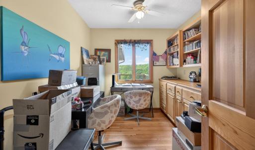 Office space with a mountain view out the window & built in shelves