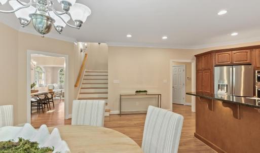 Breakfast area looking towards back staircase that leads to second level of home.  Formal dining to the right.