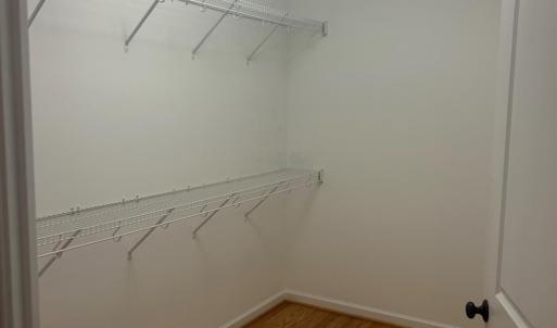 Spacious walk in closet in primary bedroom.