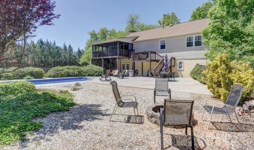 Fenced pool, fire pit area with large oversized patio area for additional seating or parties