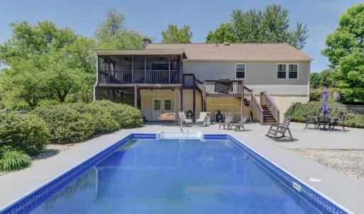 Large fenced pool area with extended pool apron and patio for entertaining.