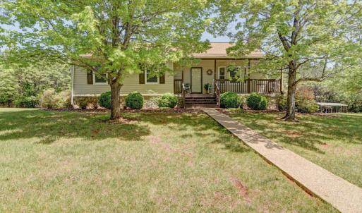 Entry to the property - with warm welcoming porch, multiple seating areas around the entire house, covered, screened and open - your choice and then opens up for a great home to make your own!