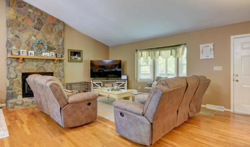 Familiy/Living Room with Rock Fireplace, Gas Logs, hardwood floors.