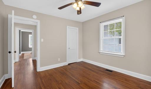 Spacious bedroom with designer updated paint and ceiling fan.