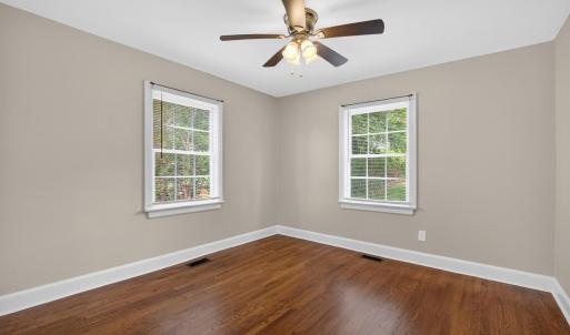 Spacious bedroom with designer updated paint and ceiling fan.