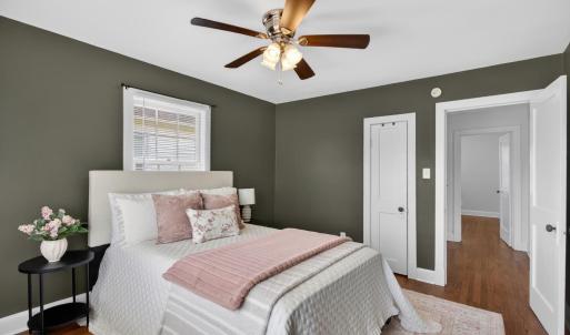 Spacious bedroom with designer updated paint and ceiling fan.