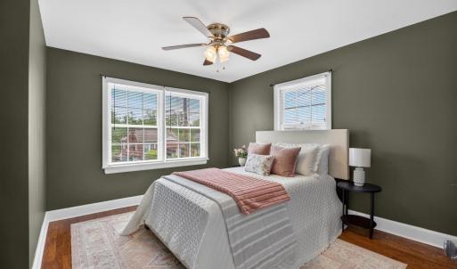Spacious bedroom with designer updated paint and ceiling fan.