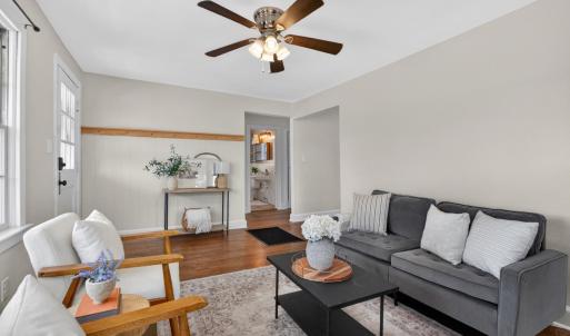 Bright living room with beautiful hardwood floors and a wood-burning fireplace.