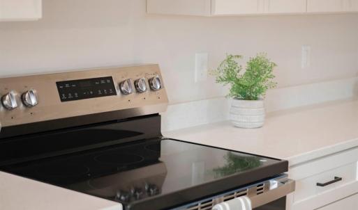Open Concept kitchen with quartz counters, oversized island, door to deck, etc *Fridge ordered and scheduled to be installed.