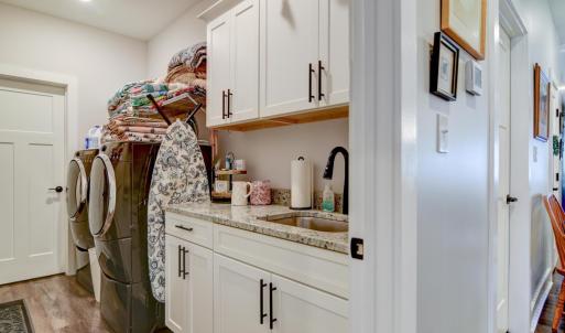 Great working Laundry room, with upper and lower cabinets (an upgrade) , with sink