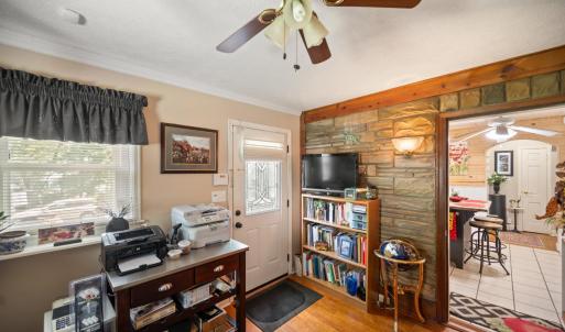 Dedicated office featuring hardwood floors and convenient access to the main living areas with a private entrance.