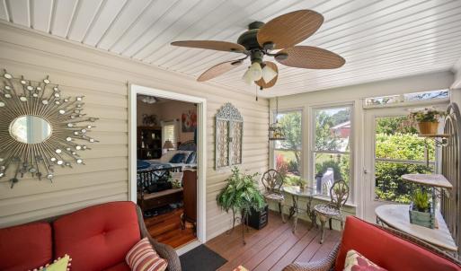 Walk out of the primary bedroom into this charming garden room filled with natural light and views of a beautifully landscaped backyard.