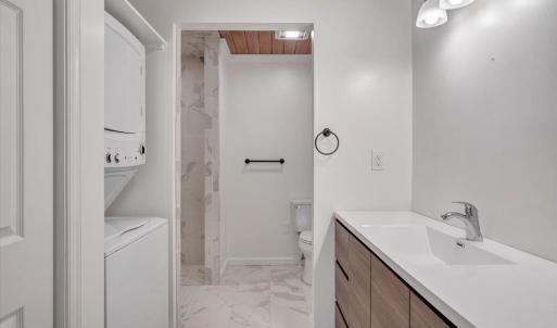 Full bath with laundry closet completes the in-law apartment.  A tankless on demand hot water system serves the in law apartment.