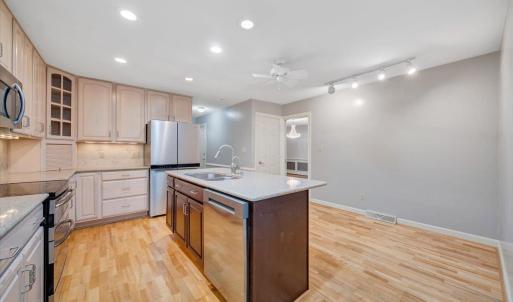 The kitchen has solid surface countertops and room for a table.