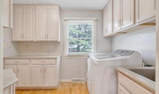Nice laundry room off the kitchen with additional cabinet space