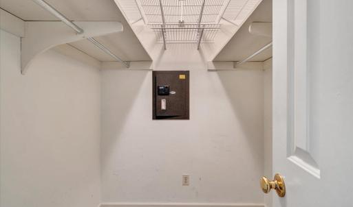 Primary bedroom closet with built-in safe