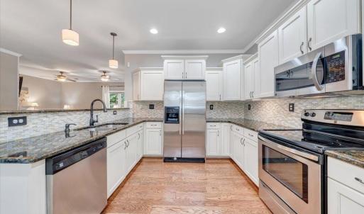 Gorgeous kitchen with granite counter tops and custom backsplash!  All appliances convey!
