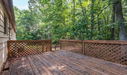 The 12x16 deck is on the back accessed from double slider glass doors at the end of the Sunporch; with stairs to the yard.