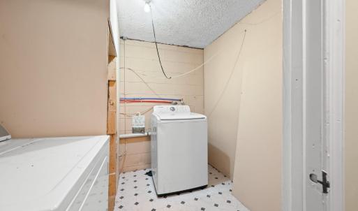 The laundry room is in the lower level just off the newly reconstructed stairs