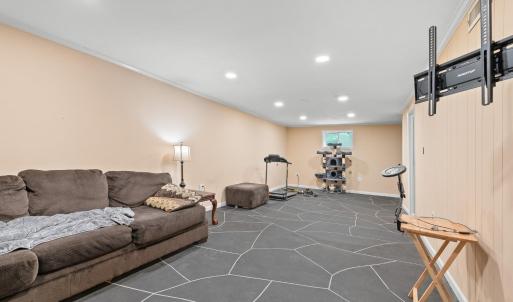 The large "rec room" on terrace level. The window wall and the wall behind the couch (front wall of house) had  carbon fiber strips installed, sump pump installed, french drain installed