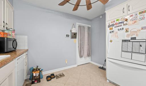 Opposite the kitchen sink. this is the door to the Sunroom