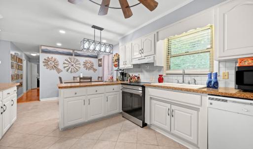 The kitchen is just off the Sunporch entrance with the eat-in area just past this island cabinet.