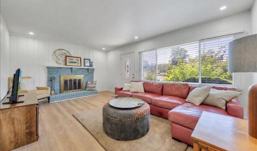 Cozy up to your wood burning fireplace in this update living room space with tons of natural lighting!