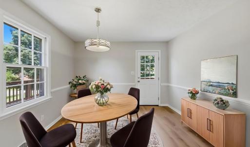 Virtually staged dining room off of kitchen with access to back deck.