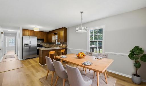 Virtually staged dining area off of kitchen.