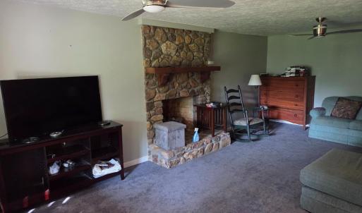Den with rock fireplace