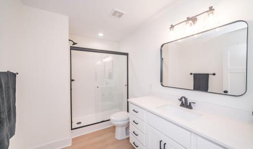 Primary bath offers shower with glass door.  Similar to photos.