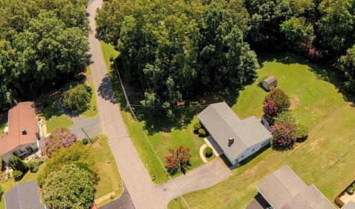 Home with adjoining lot, wooded area to the left of the home.