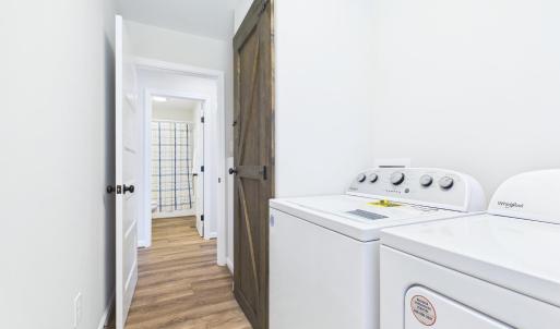 Dedicated Laundry Room provides additional Storage and Everyday Convenience.