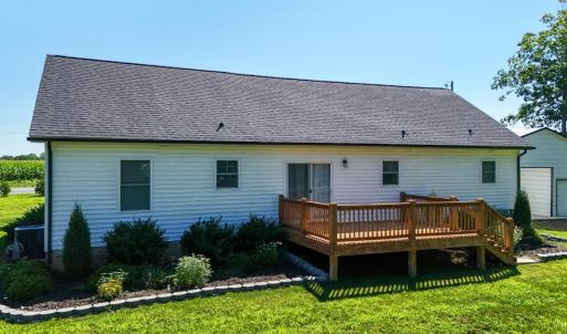 Spacious Rear Deck overlooks the Level Backyard with Established Landscaping and Outdoor Living Space.
