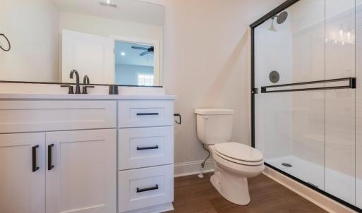 Primary Suite with vaulted ceilings, walk in closet and en suite full bathroom.