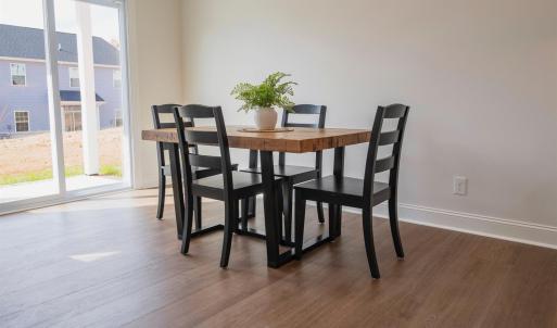 Open concept living room into dining and kitchen area on main floor.  Finishes may not be identical but similar.
