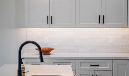 Custom kitchen with quartz counters, tile backsplash, all stainless applicants includes. Finishes may not be exact, but will be similar.