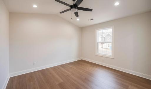 Primary Suite with vaulted ceilings, walk in closet and en suite full bathroom.