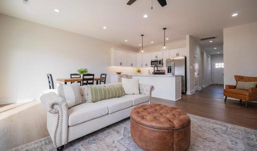 Open concept living room into dining and kitchen area on main floor.  Finishes may not be identical but similar.