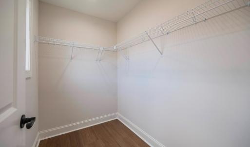 Primary Suite with vaulted ceilings, walk in closet and en suite full bathroom.