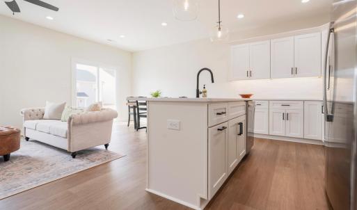 Open concept living room into dining and kitchen area on main floor.  Finishes may not be identical but similar.