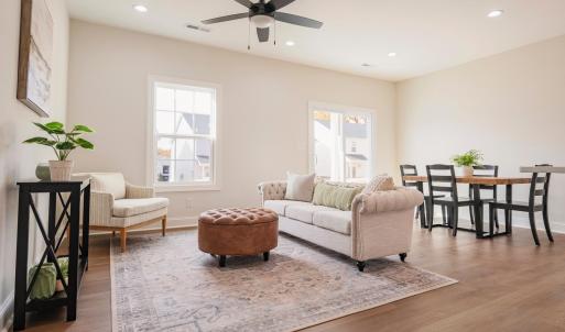 Open concept living room into dining and kitchen area on main floor.  Finishes may not be identical but similar.