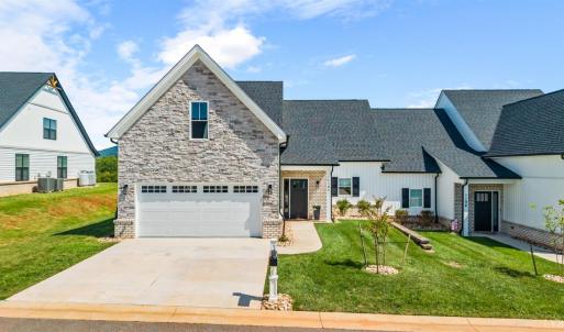 Beautiful stone, vinyl and brick exterior with flat concrete driveway