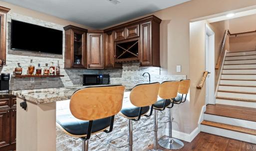 Terrace level bar with sink, dishwasher, refrigerator.