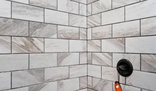 Primary shower and river stone shower floor.
