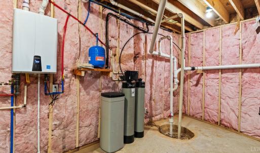 Tankless hotwater heater, water softener, and storage area.