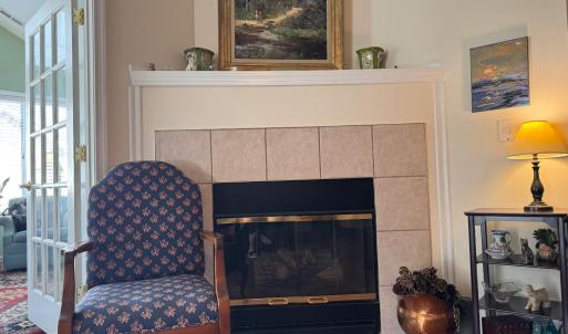 Just to the side of the Sunporch door is the gas logs fireplace.